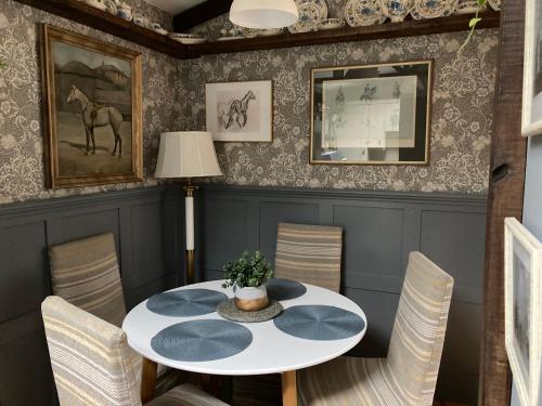 a dining room with a white table and chairs at Ballybur Lodge Mews 2 in Kilkenny