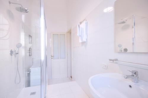 a white bathroom with a sink and a shower at Right House via Sulis 23 - Best Neighborhood in Town in Cagliari