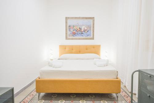 a bed in a room with a picture on the wall at Right House via Sulis 23 - Best Neighborhood in Town in Cagliari
