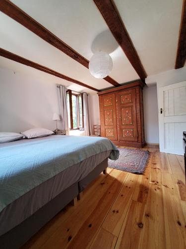 a bedroom with a bed and a wooden floor at Gite classé "Le tilleul" in Colmar