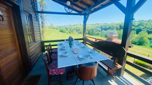 a table on the porch of a house with a view at House for rent Mrežnica in Duga Resa
