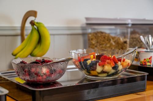 two bowls of fruit on a tray with bananas at Riverside in Ullapool