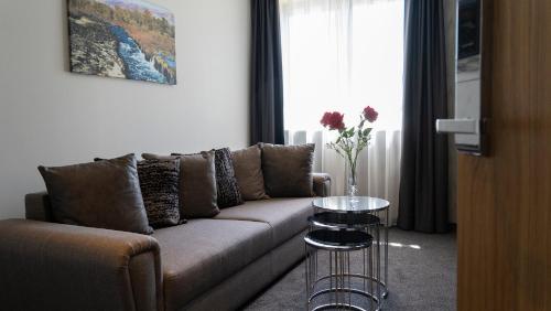 a living room with a couch and a table at HA Hotel Mostar in Mostar