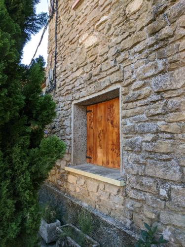 a stone building with a wooden door on it at EL PINAR DE BARDENA in Carcastillo