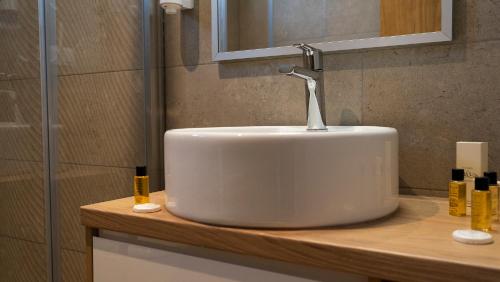 a white sink with a faucet on a counter in a bathroom at HA Hotel Mostar in Mostar