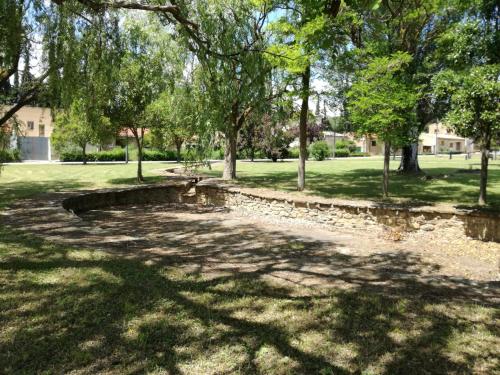 a park with a bench in the shade of trees at EL PINAR DE BARDENA in Carcastillo