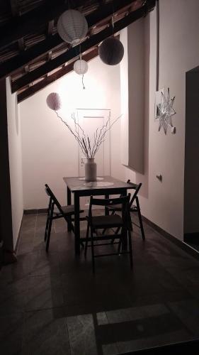 a table and chairs in a room with a vase on it at Vikendica Gaj in Gornji Milanovac