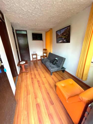 a living room with a couch and a table at Mi Pueblito Lodge in Huancayo
