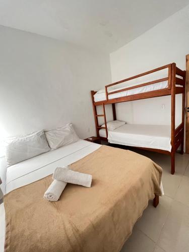 a bedroom with two bunk beds with a towel on the bed at Villa Mar Residence in Jericoacoara