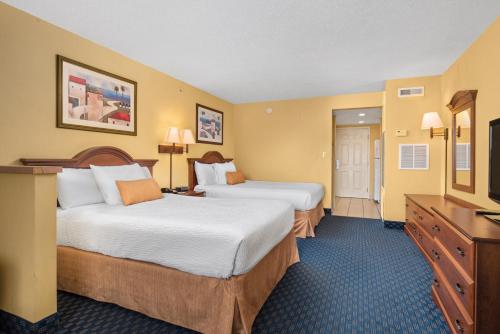 a hotel room with two beds and a television at Bonita Beach Hotel in Ocean City