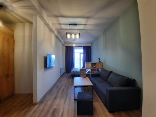 a living room with a couch and a table at Suwon in Kechi House in Tsaghkadzor