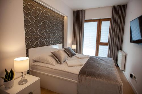 Säng eller sängar i ett rum på Apartament Greno Kielce