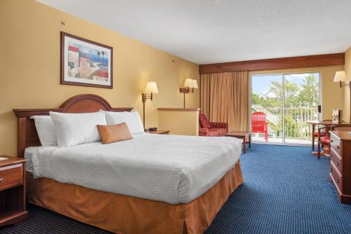 a hotel room with a bed and a balcony at Bonita Beach Hotel in Ocean City