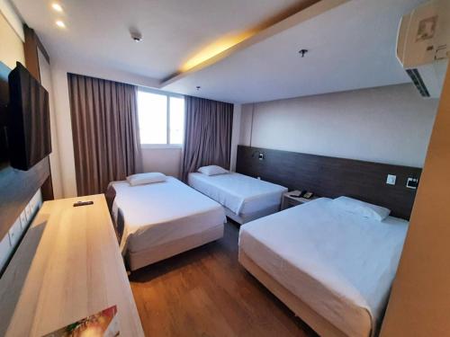 A bed or beds in a room at Ibiza Plaza Hotel