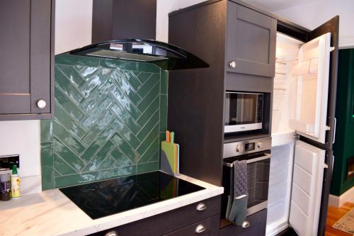 a kitchen with a glass counter top in a kitchen at Private All-Weather Hot Tub Apartment, Free Parking, 1 Mile to City Centre, Cafés & Dining Nearby in Jesmond