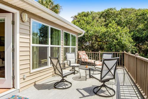 a patio with chairs and a table on a house at Compass Rose II in Folly Beach