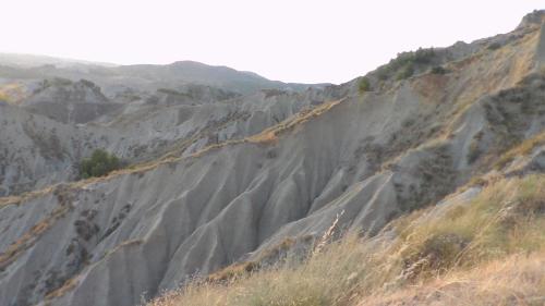 a mountain side with rocks and grass on it at Soprattutto in Montalbano Jonico