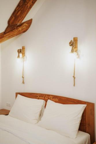 a bedroom with a bed with two crosses on the wall at Hanul lui Mujdei in Vatra Dornei