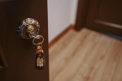 a close up of a door knob on a door at Hanul lui Mujdei in Vatra Dornei