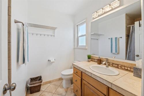 a bathroom with a sink and a toilet and a mirror at 104-unit 4 in San Diego
