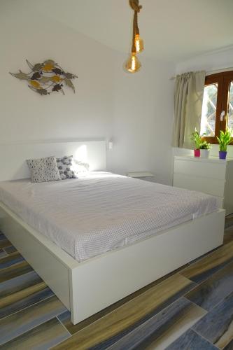 Un pat sau paturi într-o cameră la Sailor's House Porto Cervo