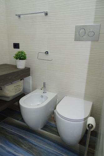 a bathroom with a white toilet and a sink at Sailor's House Porto Cervo in Porto Cervo