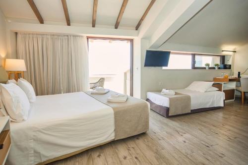 a hotel room with two beds and a table at Fedriades Delphi Hotel in Delfoi