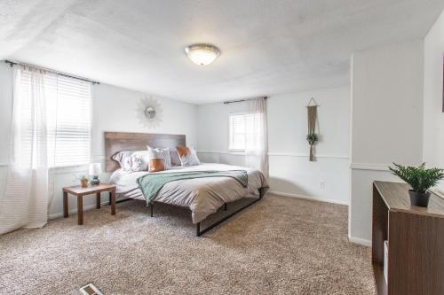 a white bedroom with a bed and a table at 3 Bedrooms House in Waldo Kansas City in Kansas City