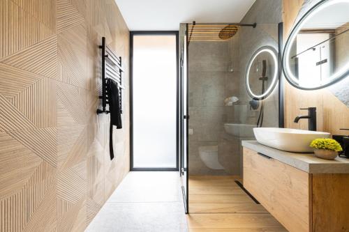 a bathroom with a sink and a mirror at Wrota Chałubińskiego in Zakopane