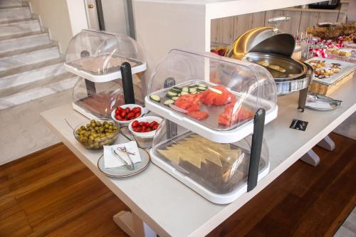 a buffet with three trays of food on a table at Fedriades Delphi Hotel in Delfoi