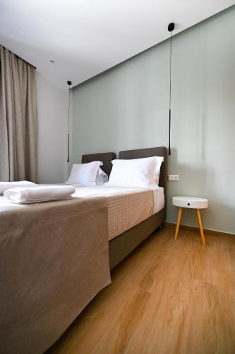 a bedroom with a large bed and a table at Eumorphia Studios & Apartments in Skiathos Town