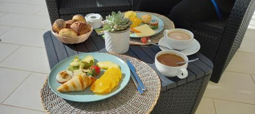 a table with two plates of food and a cup of coffee at Bowen, Luxury Suites in Lagos