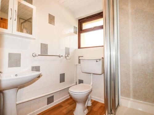 a bathroom with a toilet and a sink at Stable Cottage in Newquay