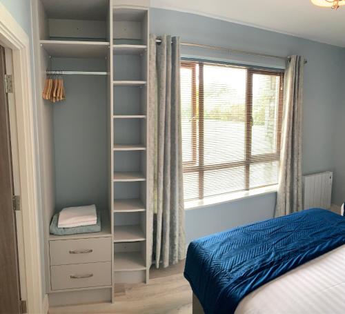 a bedroom with a book shelf next to a bed at Mountain View Apartment in Killarney