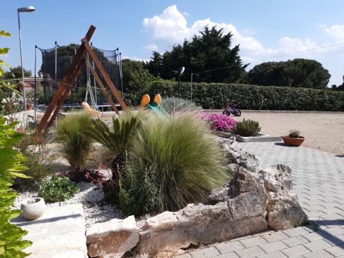 a garden with a playground in a park at Il Rifugio di Farinella in Putignano