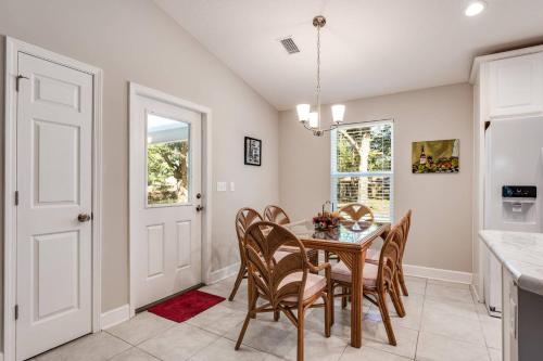 a kitchen and dining room with a table and chairs at Moody Oaks in Orange Park