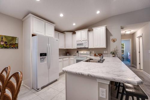 a kitchen with white cabinets and a white refrigerator at Moody Oaks in Orange Park