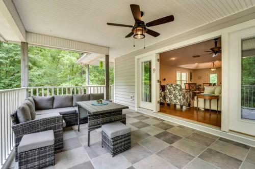 a screened porch with a couch and a ceiling fan at The Tree House in Middleburg