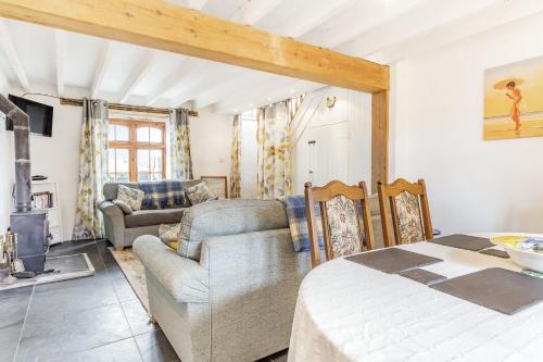 a living room with a couch and a table at Victoria Cottage in Newquay