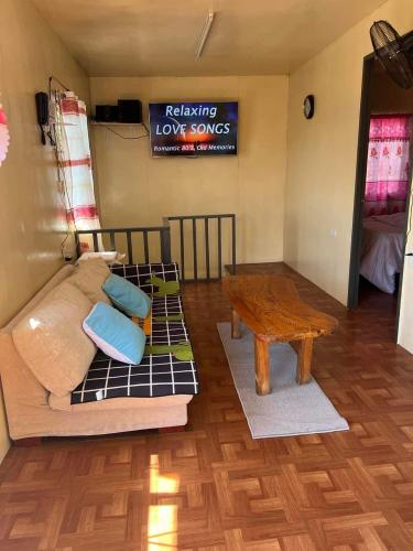 a living room with a couch and a table at Serenity House in Baguio