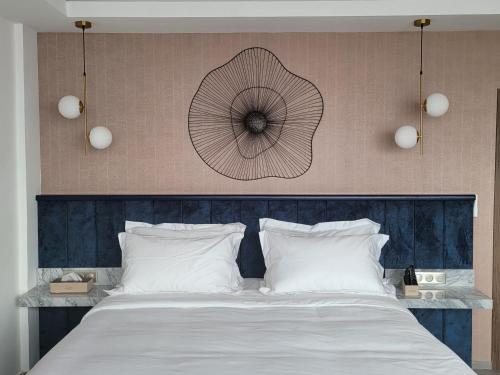 a bedroom with a large bed with white pillows at Appartements Lamblin in Abidjan