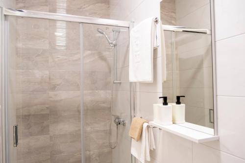 a shower with a glass door in a bathroom at Apartment Elite Residence in Mostar