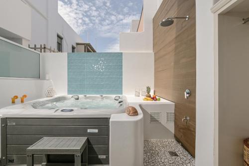 a bathroom with a tub and a sink at Blue Sky Summer in Naxos Chora