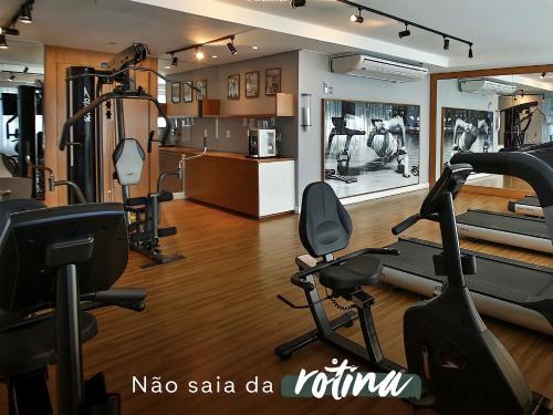 a gym with treadmills and exercise bikes in a room at True América apart-hotel in Campos dos Goytacazes