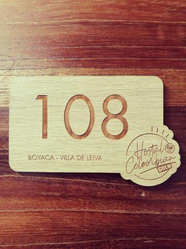 a wooden house number on a wooden table at Hostal Colombian Gold in San Gil