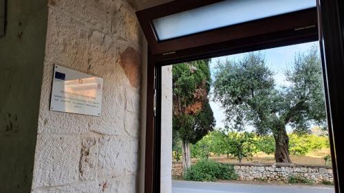 a sliding glass door with a view of a tree at DIMORA PATRIZIA in Triggianello