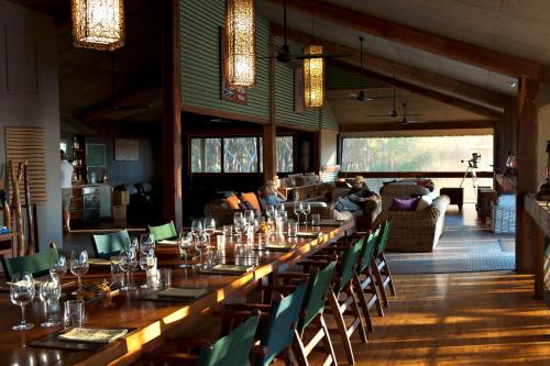 a long table in a room with chairs and people at Bamurru Plains in Point Stuart