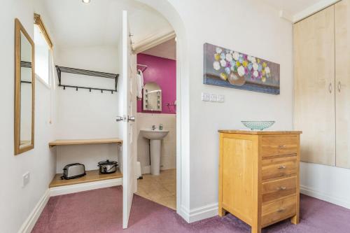 a bathroom with a sink and a dresser in a room at The Friendly Room in Austwick