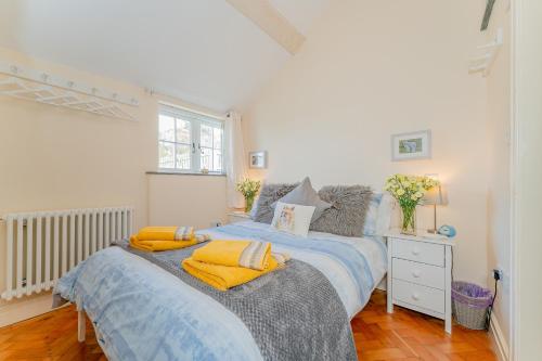 a bedroom with two beds and a window at Quarry Cottage in Llanasa