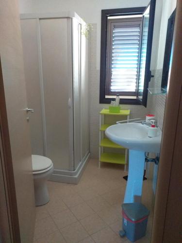 a bathroom with a sink and a toilet and a shower at The White Rocks in Noto Marina